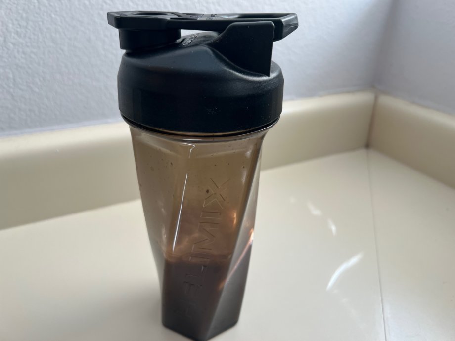 The Helimix Vortex Shaker Bottle on a counter with a protein shake in it