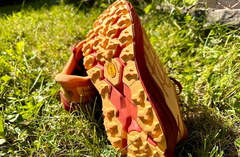 HOKA Speedgoat sneakers placed on grassy ground