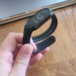 person holding xiaomi mi band 8 fitness tracker