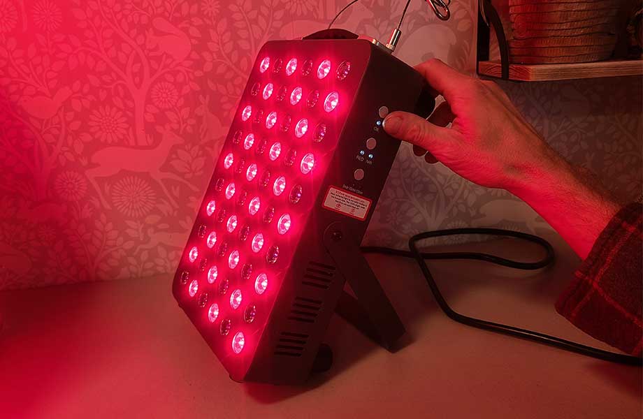 Person turning on the Hooga Red Light Therapy Panel