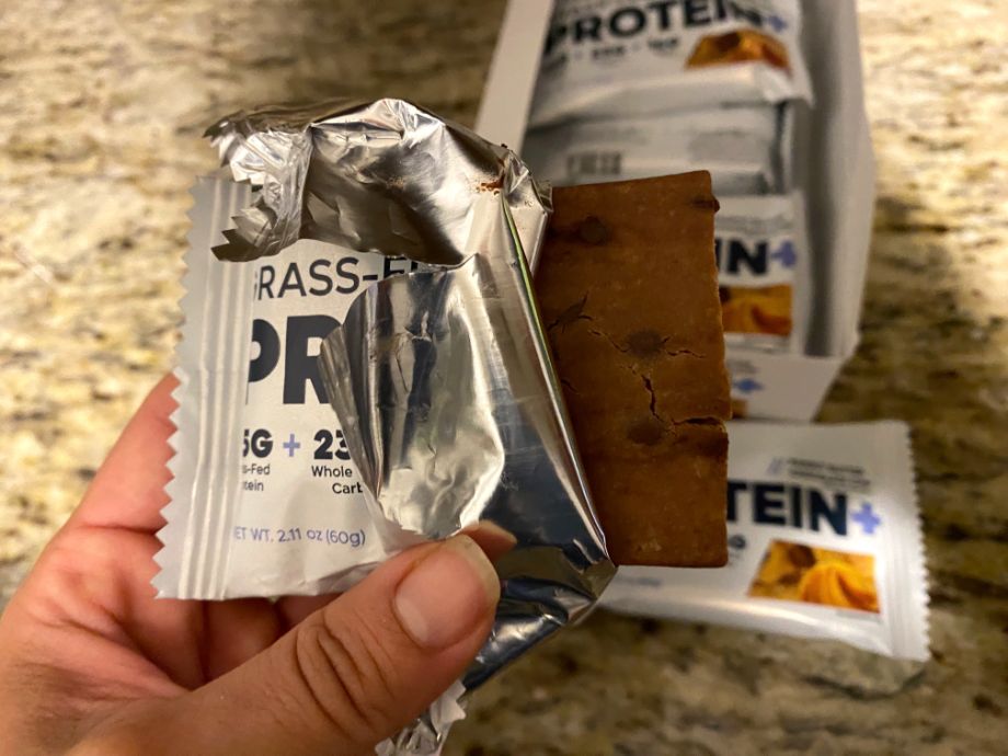 Someone holding a Transparent Las Grass-Fed Protein+ Bar