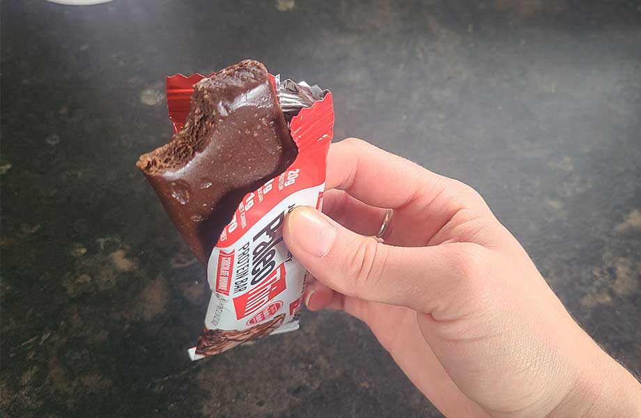 Julian's Bakery Paleo Thin Protein Bar with a bite taken out.