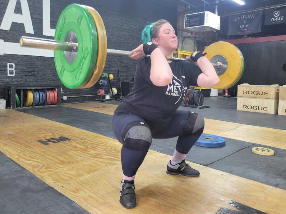 A clean front squat in kcross weightlifting shoes.