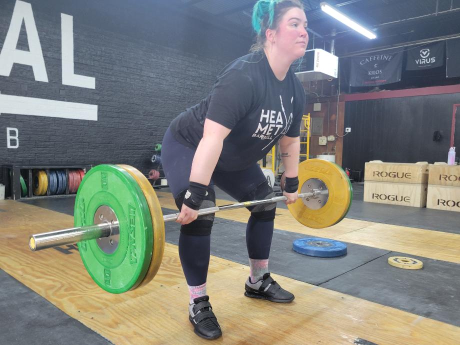 A woman doing a clean pull with kcross Weightlifting Shoes.