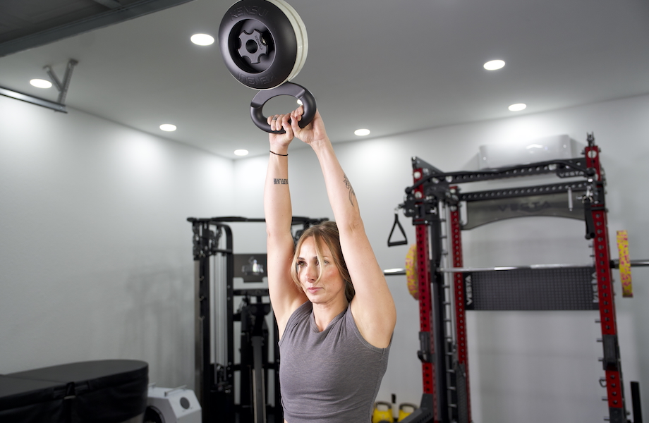 Lindsay Scheele performing an overhead kettlebell swing with the Kensui EZ-BELL