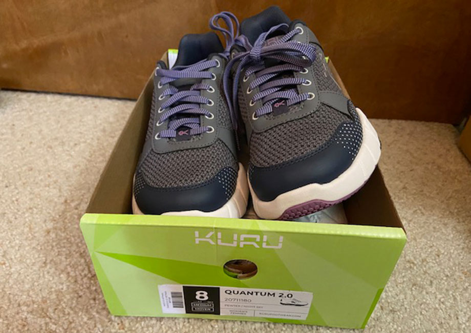 A pair of new KURU QUANTUM 2.0 shoes spills out of a freshly-opened shoebox.