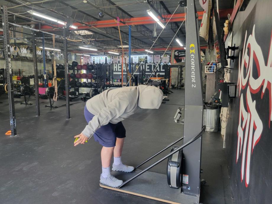 Man using a Ski erg while wearing the Kutting Weight Hoodie V4