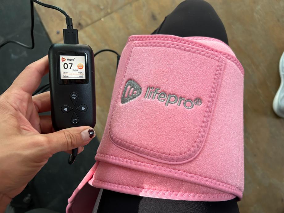 Lifepro red light therapy belt on a person's leg