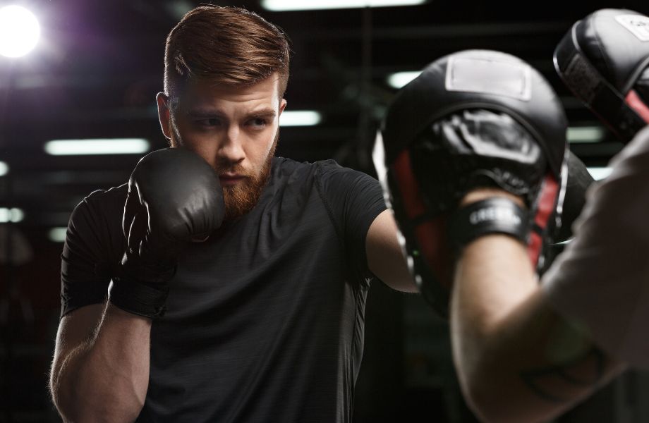 Man boxing with a partner.