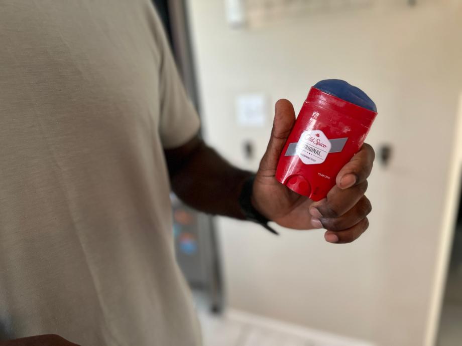 Man holding Old Spice Original Deodorant with no cap