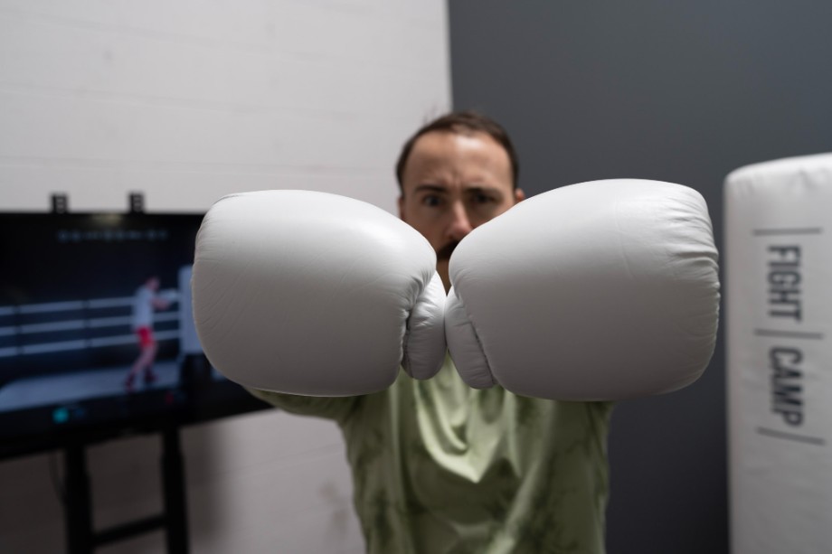 Coop poses with boxing gloves.