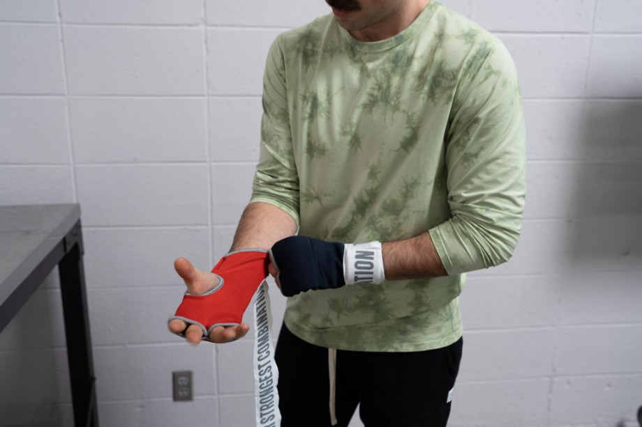 Coop wraps his hands before putting on boxing gloves.