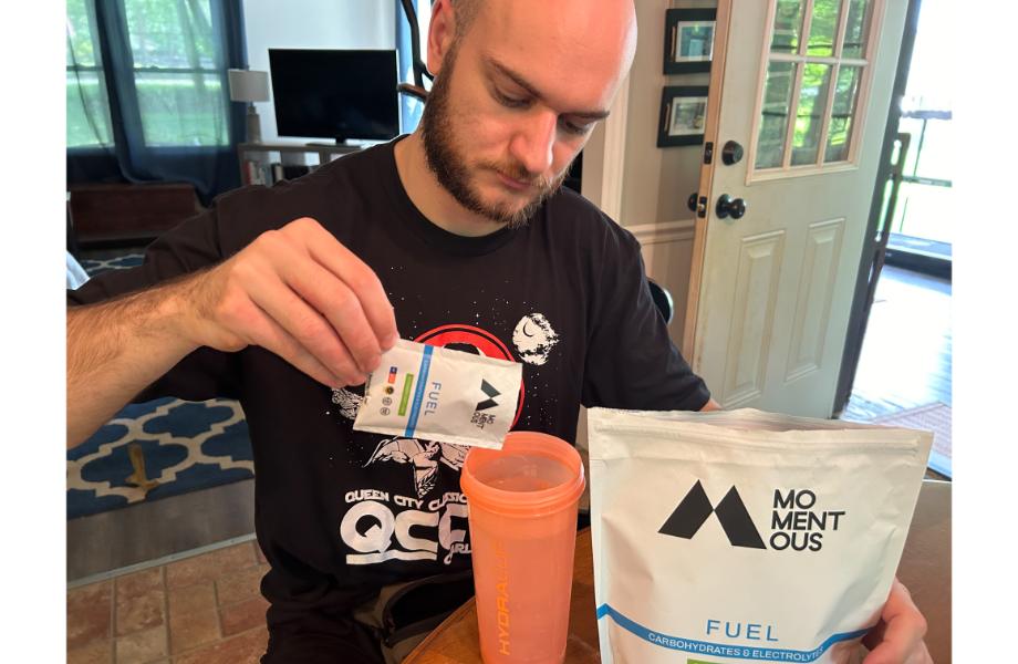 Man pouring Momentus Fuel into a shaker cup