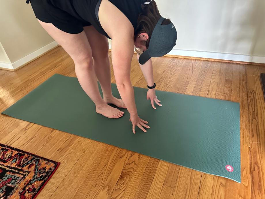 A person stretches on the Manduka PRO Yoga Mat.