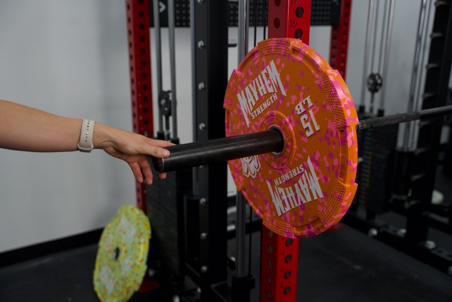 Mayhem Strength Bumper Plates on a barbell