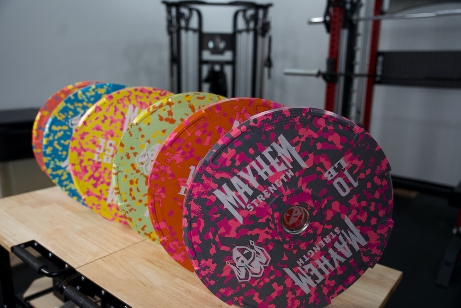 An array of Mayhem Strength Bumper Plates, viewed from the side