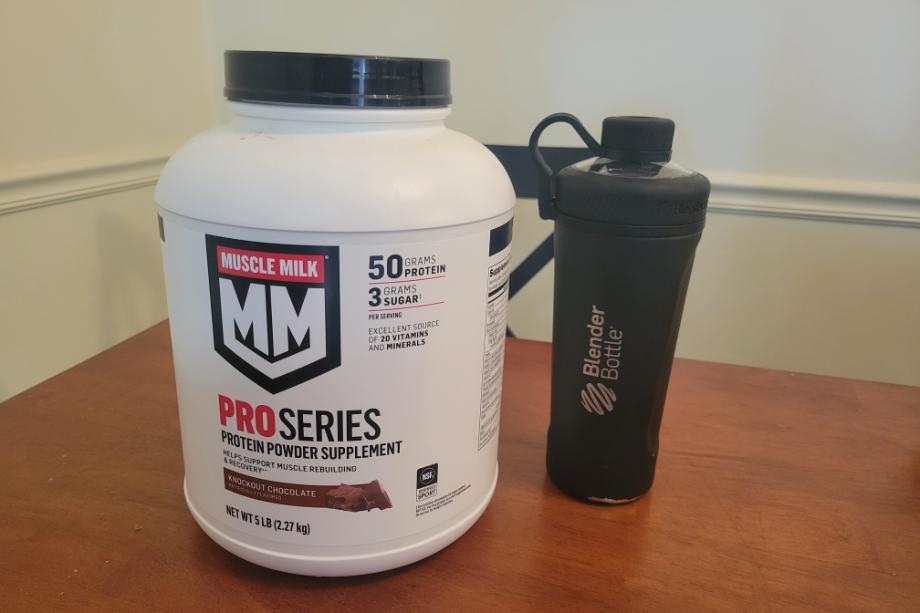 A container of Muscle Milk Pro Series protein powder and a shaker bottle