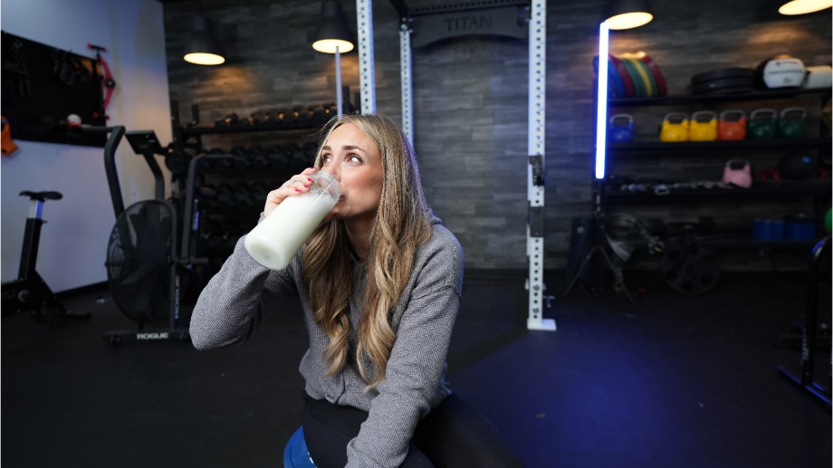 A person drinks a Naked Casein shake.