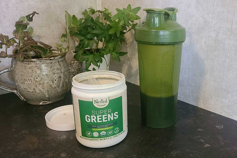 https://www.garagegymreviews.com/wp-content/uploads/nested-naturals-super-greens-powder-and-a-shaker-bottle.jpg