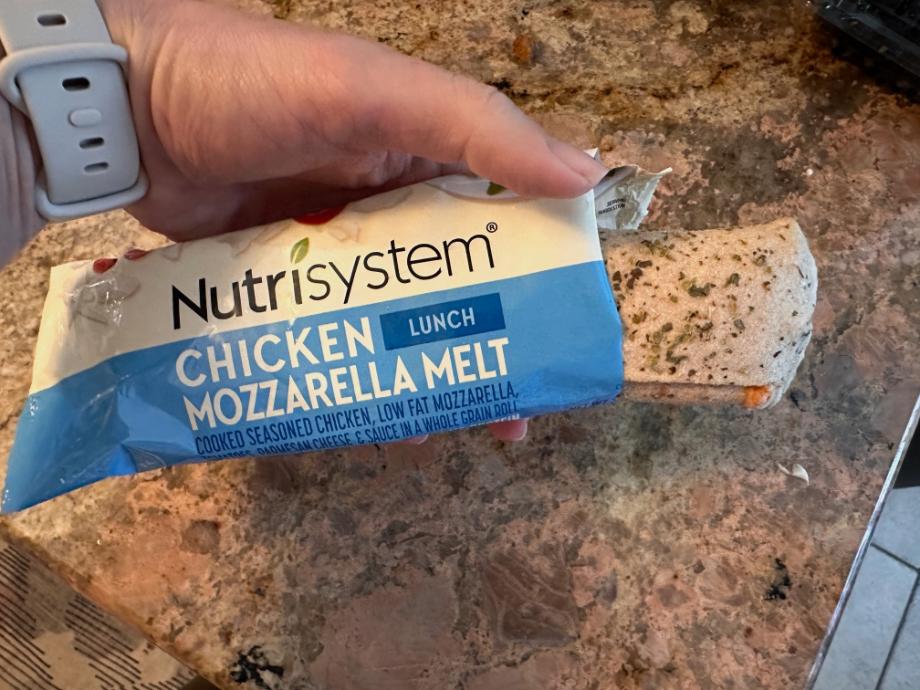 Holding a Nutrisystem Chicken Mozzarella Melt meal