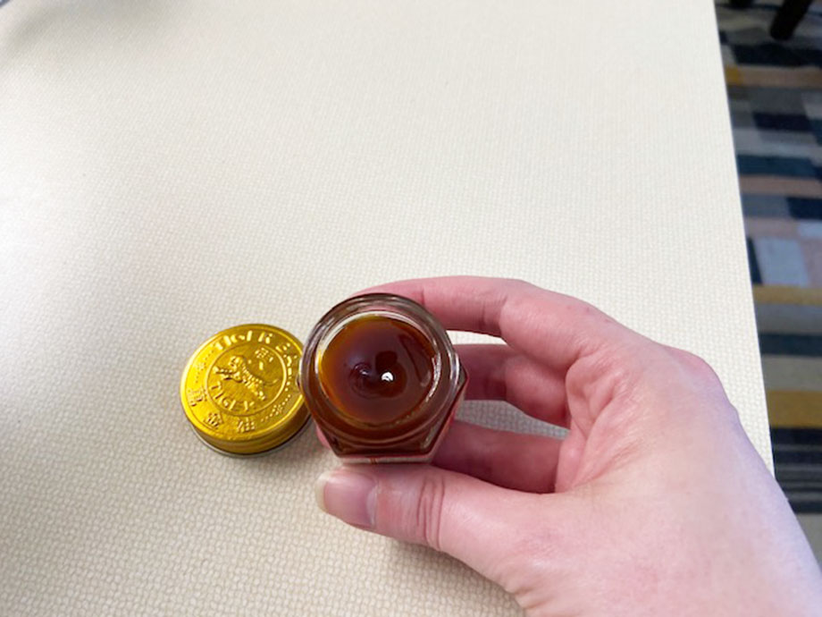 Looking down into an opened container of Tiger Balm.