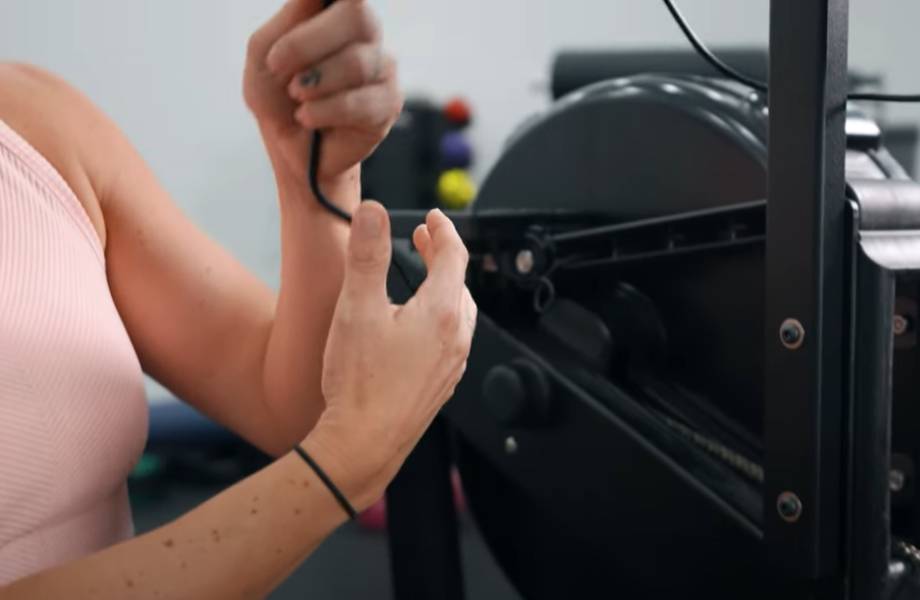 A person adjusting the wires on the myrow monitor