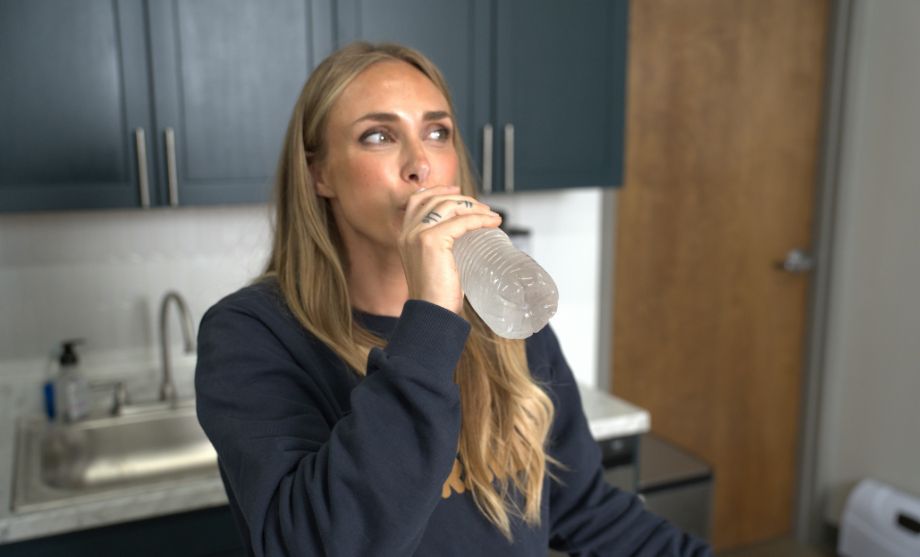 Person drinking from a water bottle