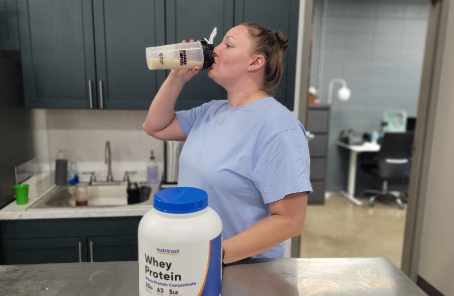 An image of a person drinking Nutricost whey protein concentrate