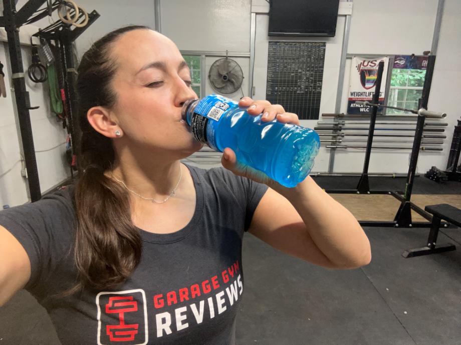 An image of a person drinking blue Powerade