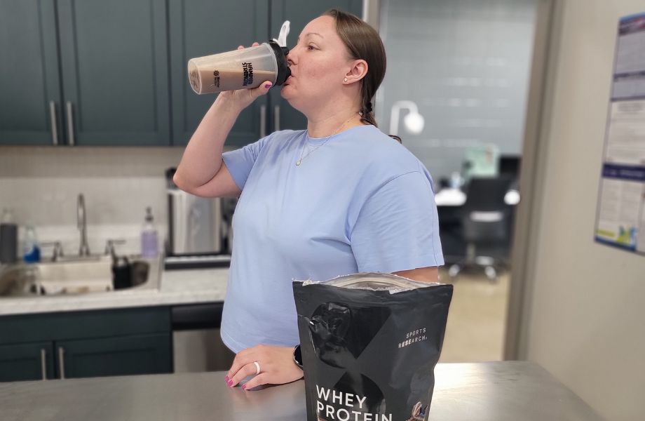 Person drinking Sports Research Whey Protein Isolate