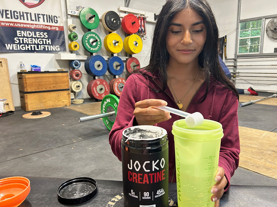 person-mixing-jocko-creatine-into-shaker-cup