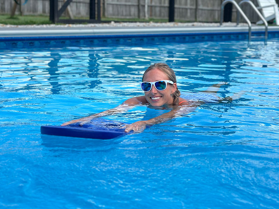 person-using-kickboard-in-pool