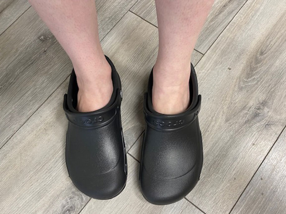 A person wearing crocs shoes