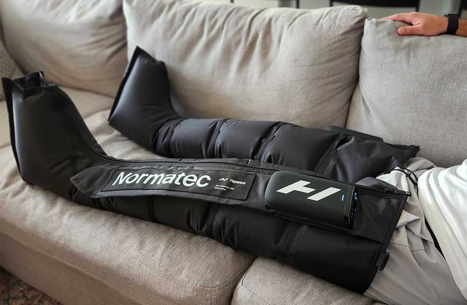 Side view of a person wearing Normatec Elite Recovery Legs.