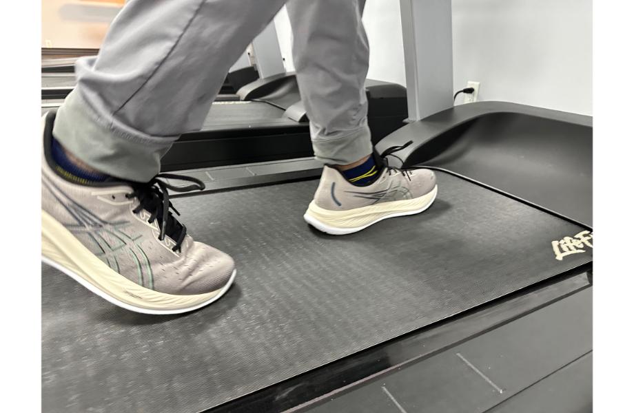 Person running on a treadmill wearing the Asics Gel Cumulus