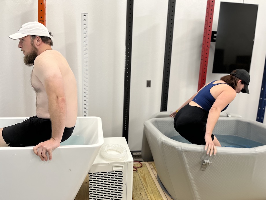 Two people getting into the Plunge and Plunge Air cold tubs, respectively