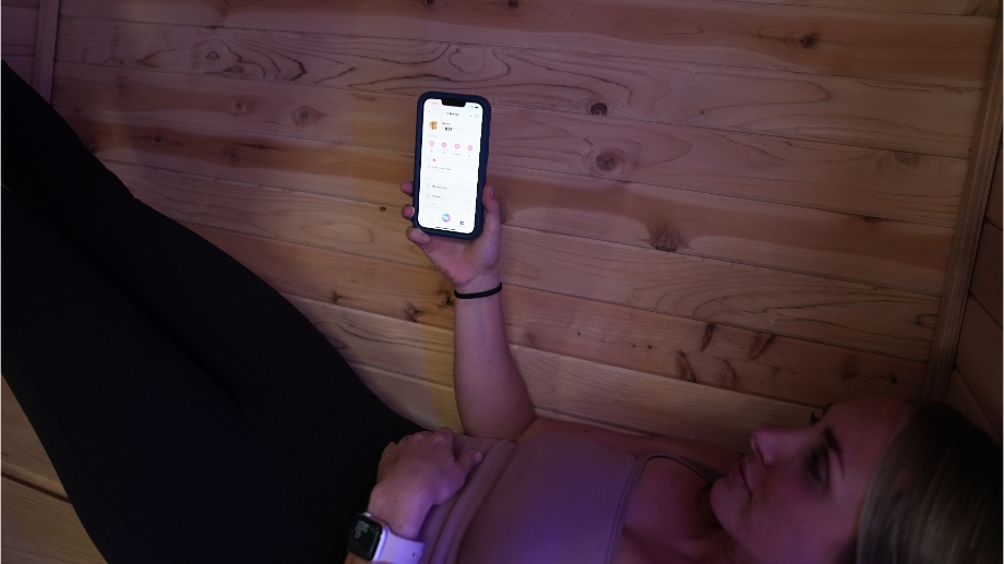 Our tester lies in the Plunge Sauna using the Plunge app.