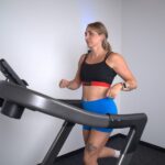 Woman running on treadmill with Polar H10 heart rate monitor