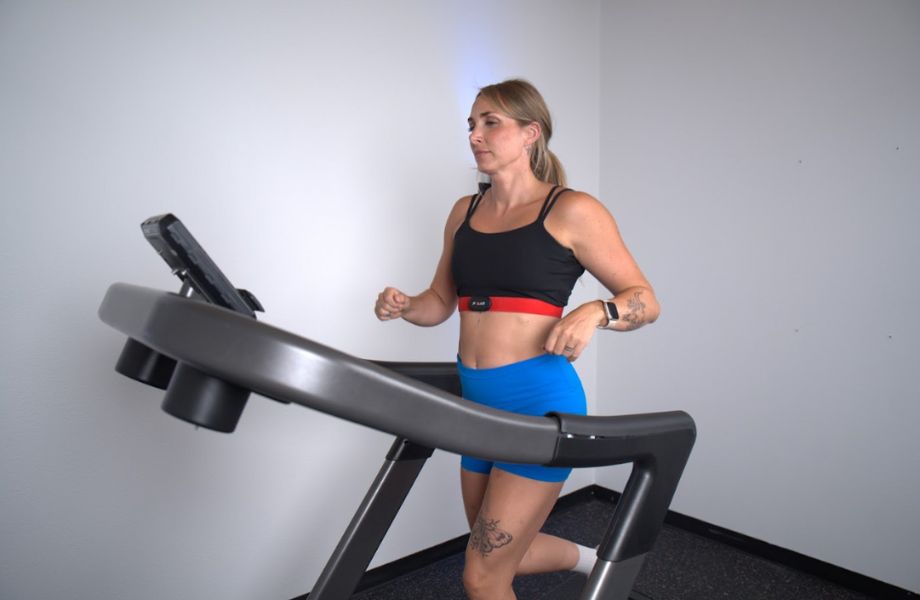 Woman running on treadmill with Polar H10 heart rate monitor