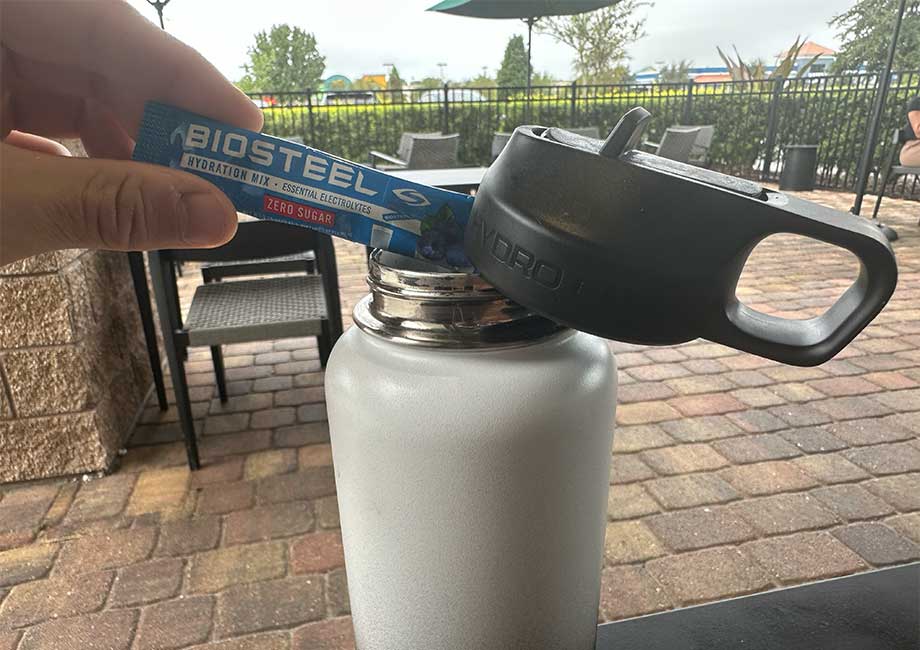 Our tester pours a packet of BioSteel Hydration Mix into a water bottle.