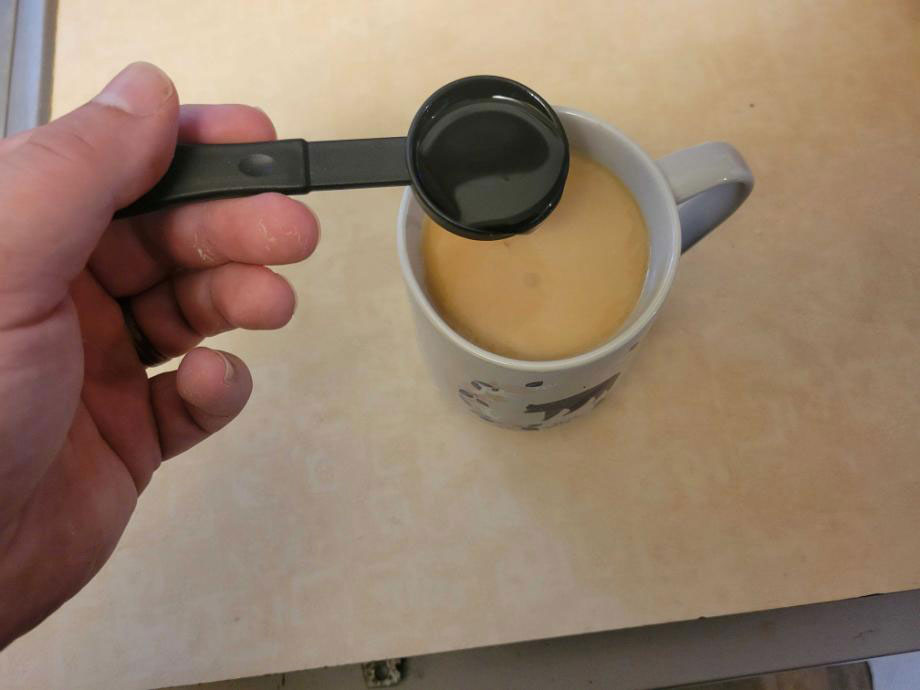 Pouring Bulletproof MCT Oil into a cup of coffee