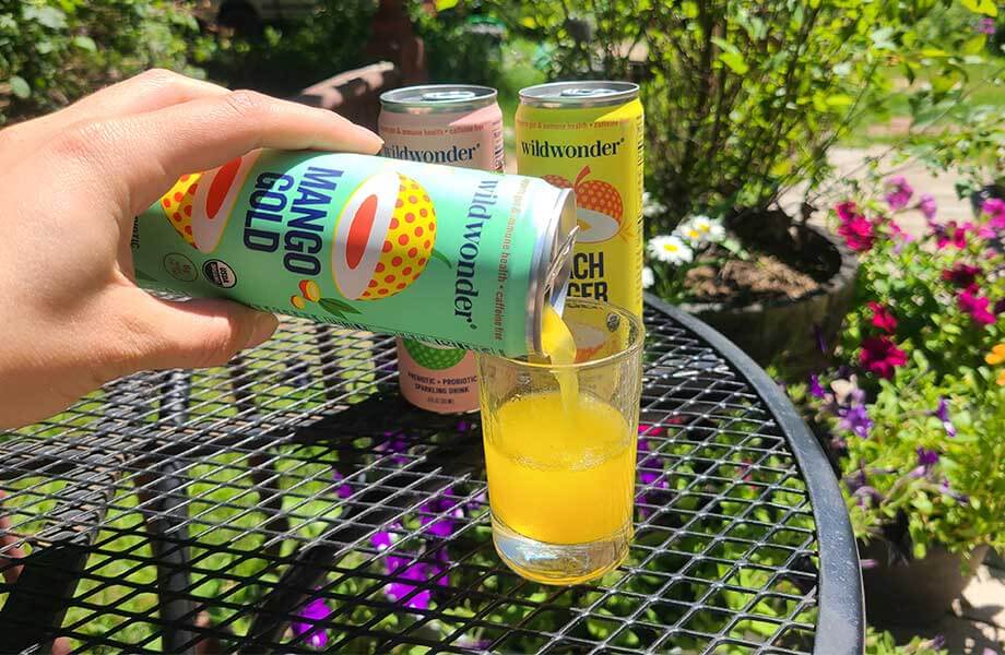 Person pouring wildwonder soda into a glass