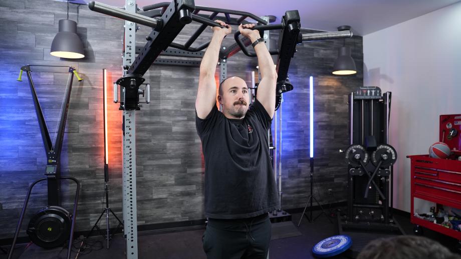 Coop does an overhead press using the PRx Halo Arms.