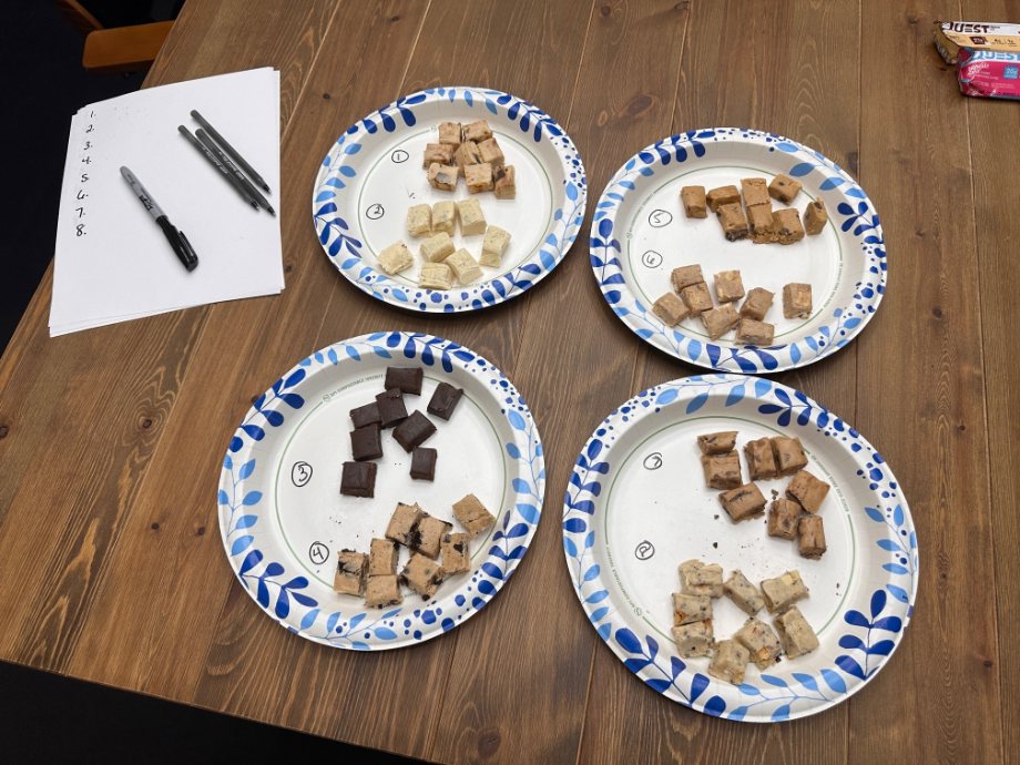 All of the test peices of Quest Bars are chopped up on paper plates.