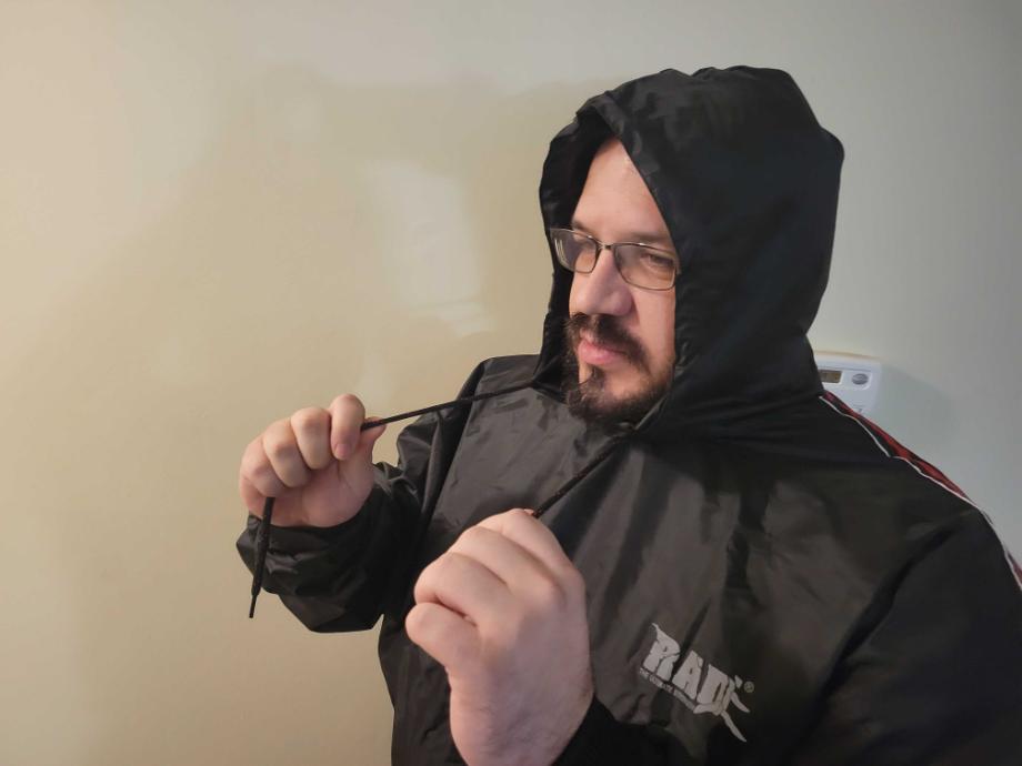 Man adjusting the hoodie string on the RAD Sauna Suit