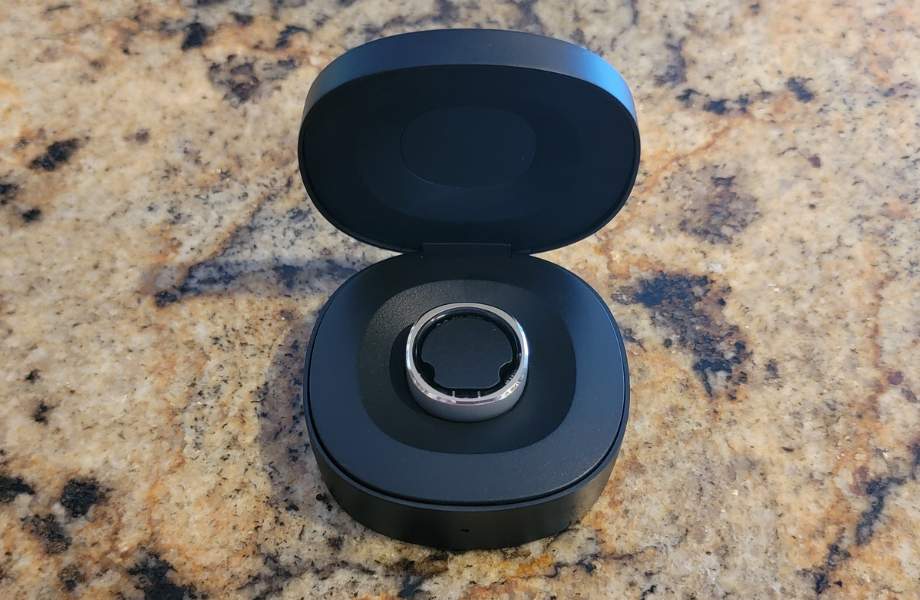 A RIngConn smart ring in it's charging case.