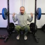 Coop performs a squat on the RitFit Smith Machine.