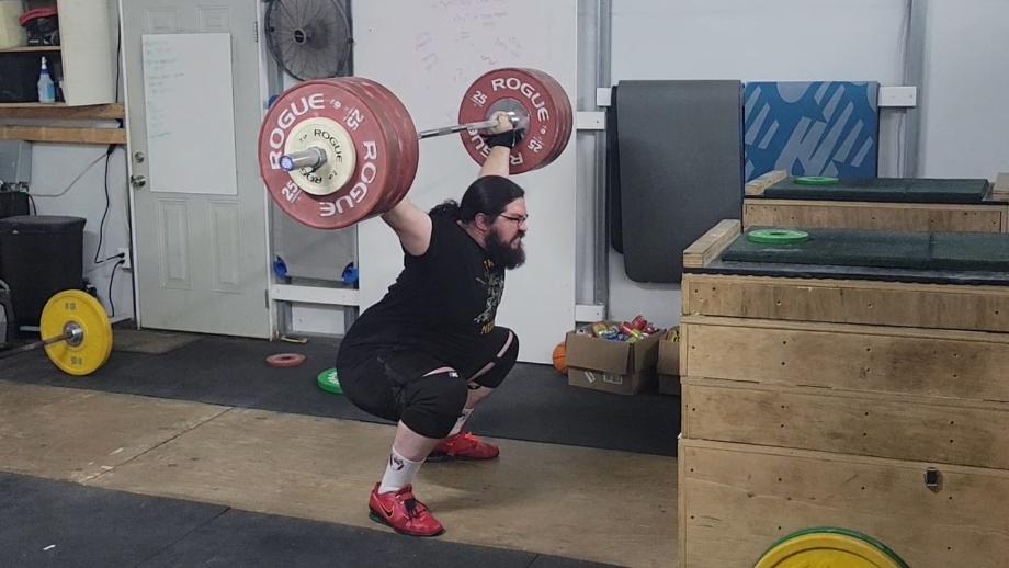 Olympian Caine Wilkes performs a perfectly-balanced snatch using Rogue Competition Bumpers.