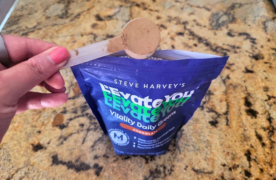 A scoop of L’Evate You Greens Powder in chocolate flavor.