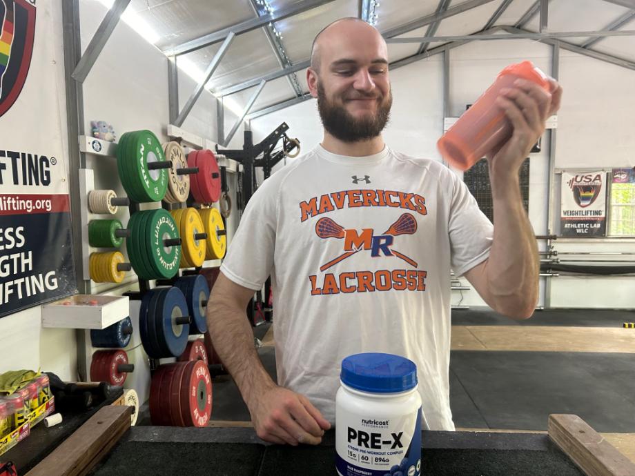 Our tester smiles while shaking up a serving of Nutricost Pre-X Pre-Workout.
